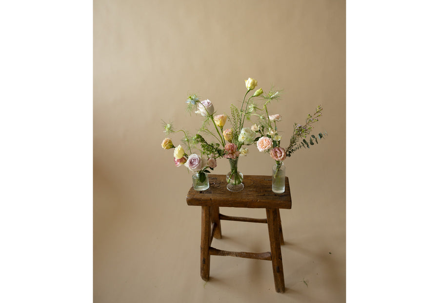 Bud Vases in Great Dixter Pastels on wooden chair