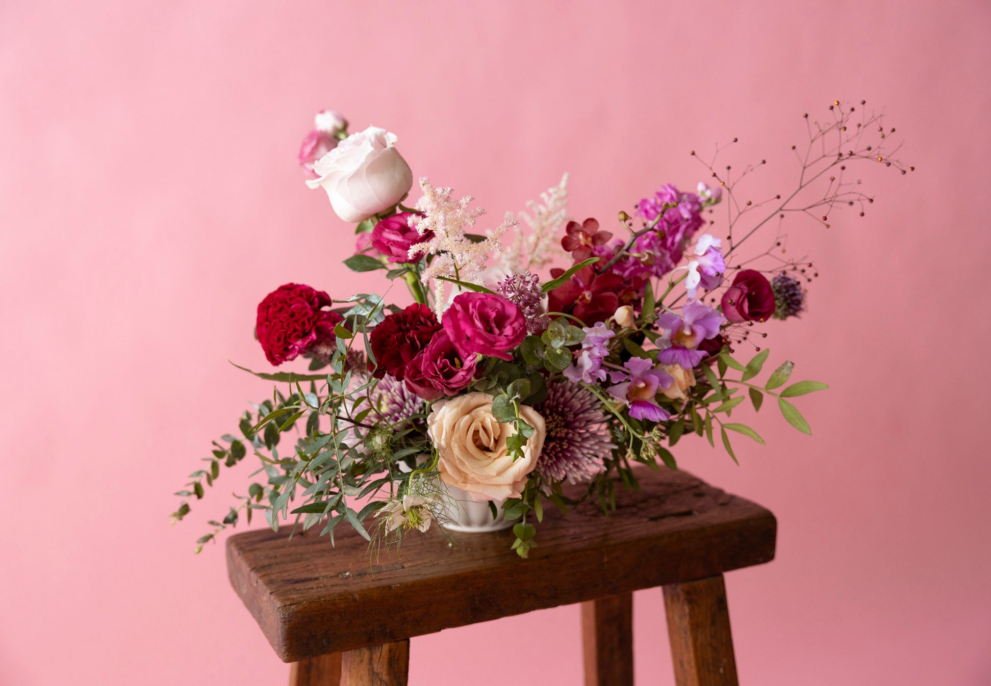 Low Table Centrepiece in Hampton Court Reds by Charlotte Puxley Flowers