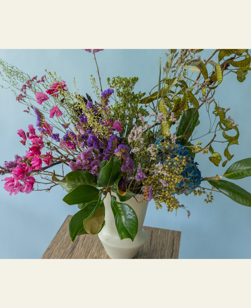 Garden-inspired dried and preserved flower arrangement in a ceramic vase by Charlotte Puxley Flowers