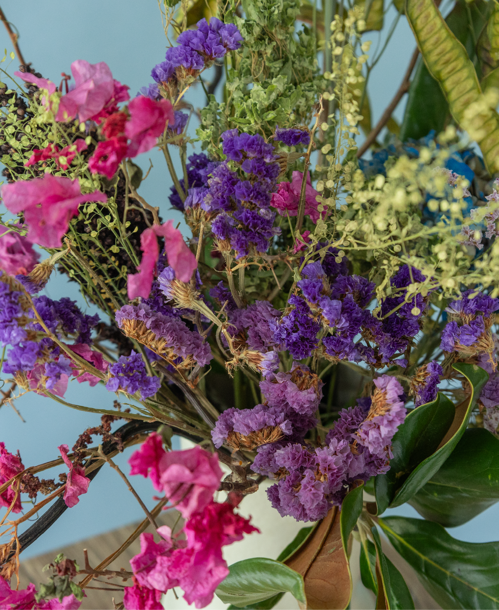 Preserved floral arrangement with natural textures displayed in a ceramic vase from the Charlotte Puxley Flowers Summer Collection