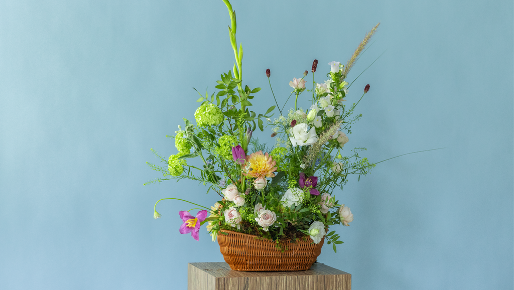 Garden-inspired basket flower arrangement featuring peonies and seasonal premium flowers by Charlotte Puxley Flowers Singapore
