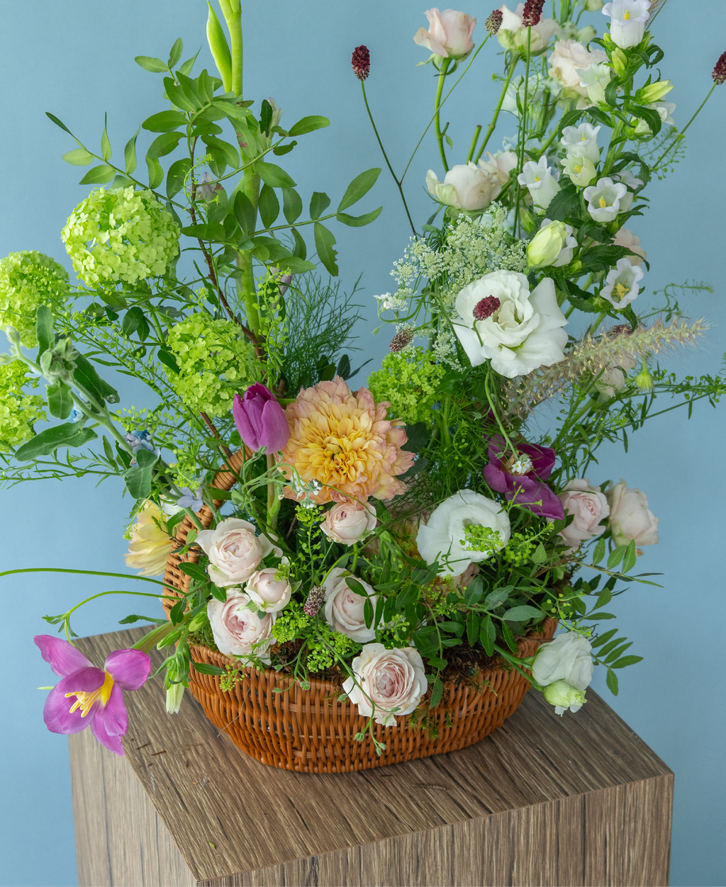 Garden-inspired basket flower arrangement featuring peonies and seasonal premium flowers by Charlotte Puxley Flowers Singapore