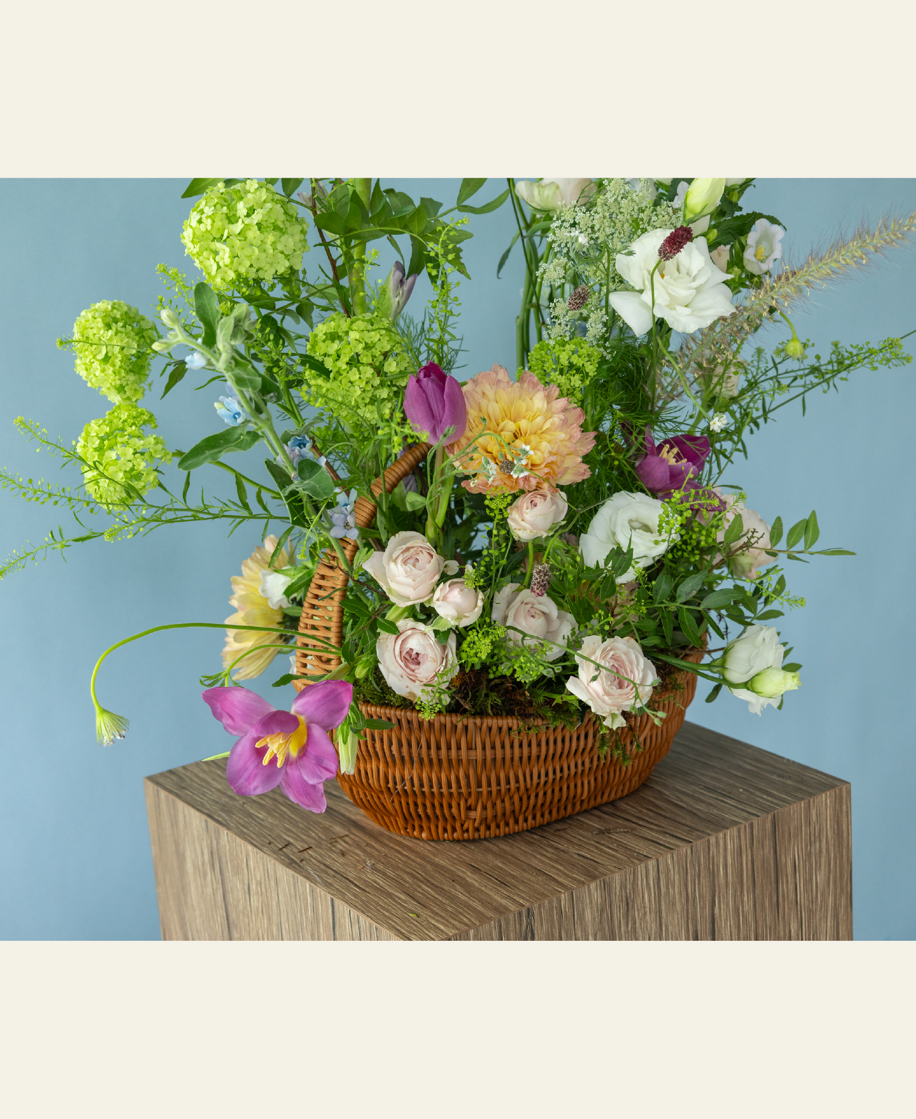 Garden-inspired basket flower arrangement featuring peonies and seasonal premium flowers by Charlotte Puxley Flowers Singapore