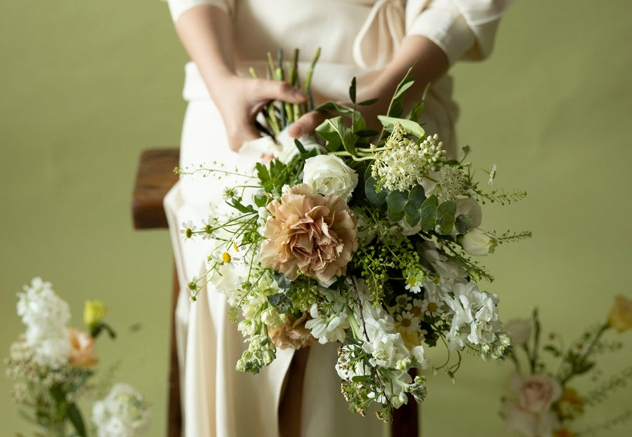 A lady hold Bridesmaids' Bouquet in Sissinghurst White
