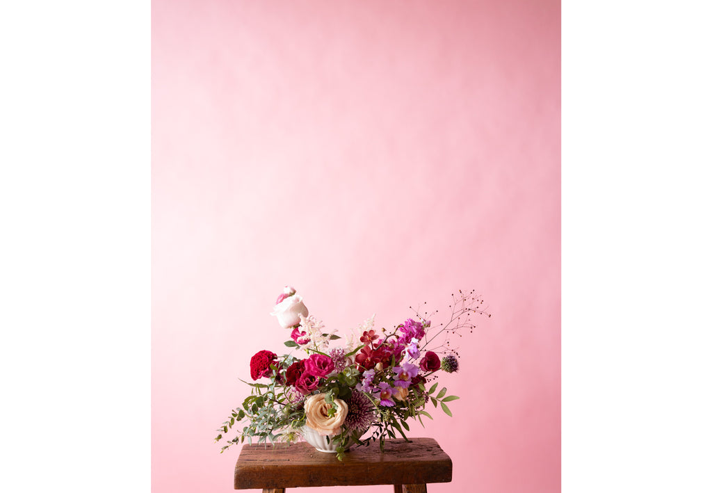Low Table Centrepiece in Hampton Court Reds on wooden chair