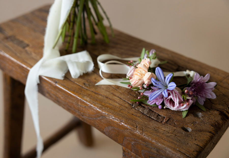 Wrist Corsages in Great Dixter Pastels on wooden table