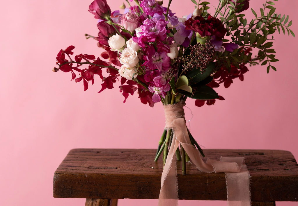 Bridesmaids' Bouquet in Hampton Court Reds on wooden table